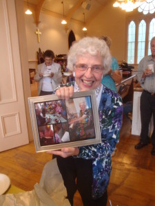 Our energetic summer music director, Marg Small shows off photos of the hymn sing.